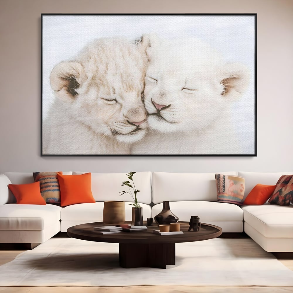 Tablou canvas cu doi pui de leu dormind imbratisati, in rama de aluminiu negru, pe perete intr-un living